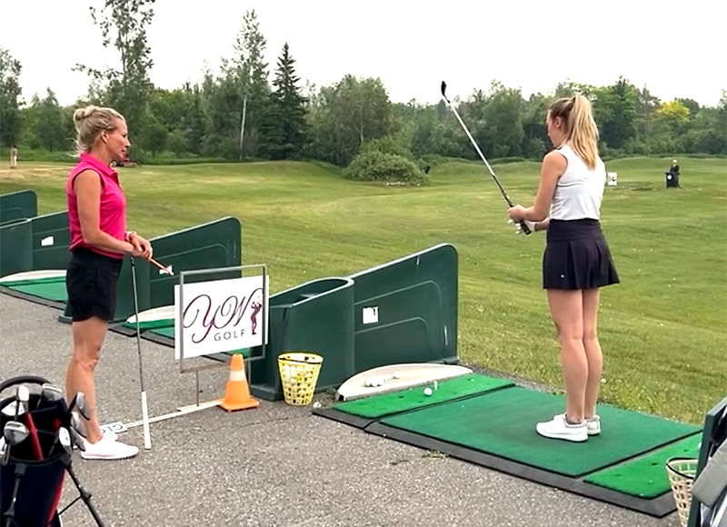 Katie Walker golf instruction at the range.